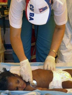 A Cuban doctor treats a Haitian child sick with Cholera. Acts of good will are key to Cuba's diplomatic styrategy. Photo by The Independent.