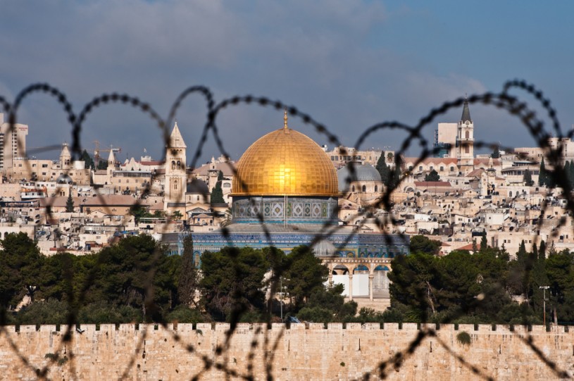 The Dome of the Rock viewed from behind barbed wire.