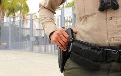 School safety concept - armed police officer on duty protecting a closed campus high school in California