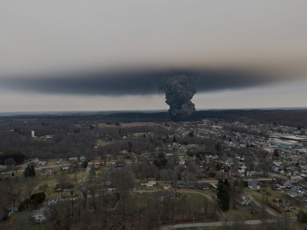 A smoke plume rises over East Palestine, Ohio as workers burn off poisonous chemicals spilled in the Norfolk Southern rail disaster.