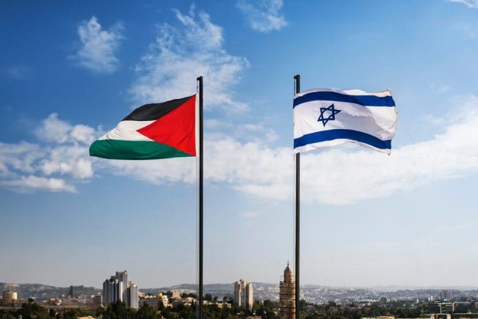 A Palestinian flag flies alongside an Israeli flag (Shutterstock)