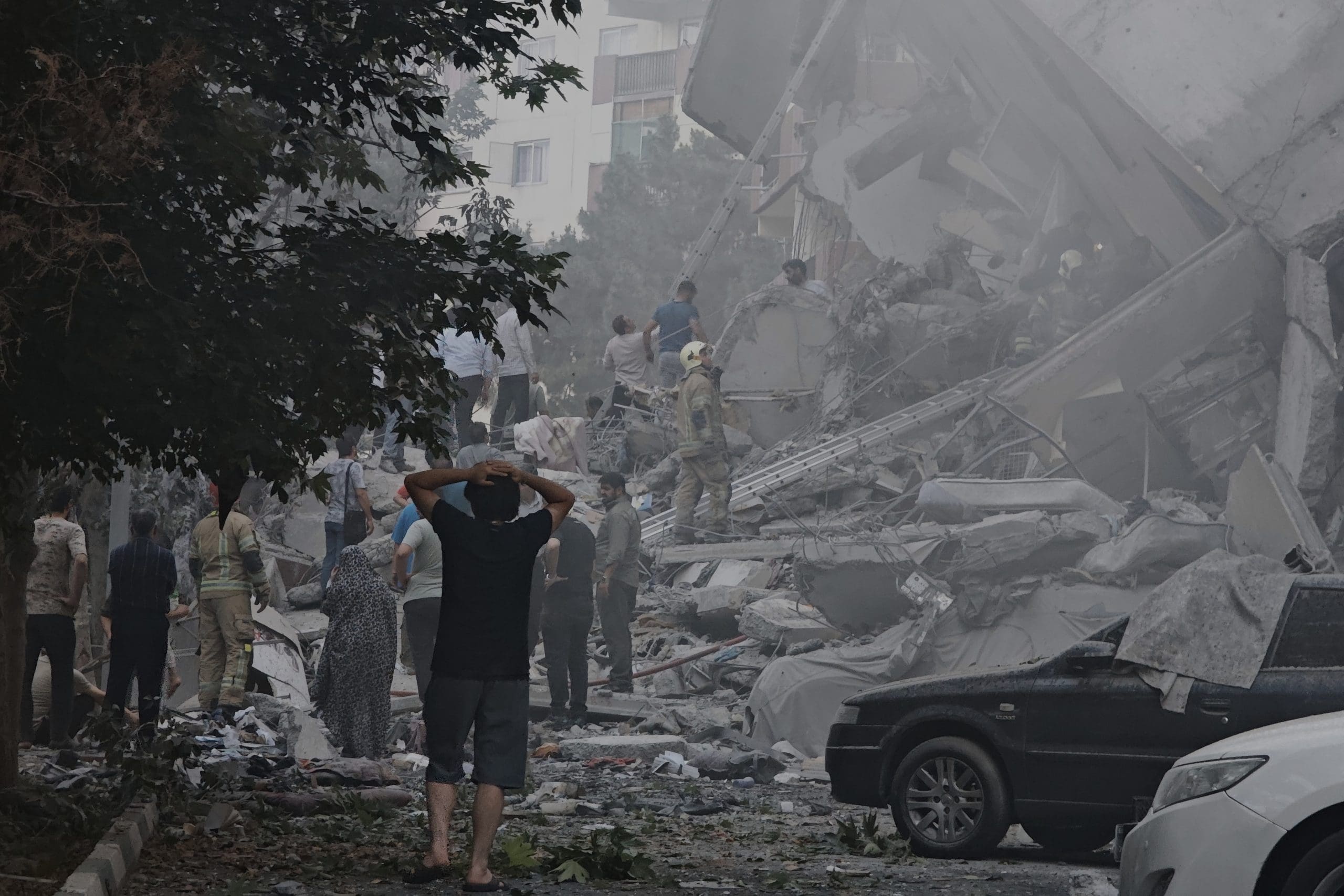 People look over damage to buildings in Nobonyad Square following Israeli airstrikes on June 13, 2025 in Tehran, Iran. Iran's three top military generals were killed in the attacks that also targeted nuclear and military facilities, according to published reports. Israel described the strikes as preemptive to keep Iran from obtaining nuclear weapons, the reports said.