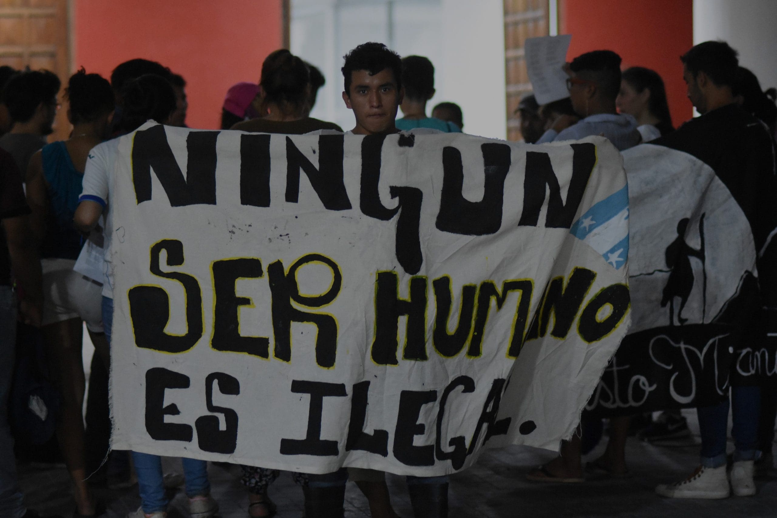Tenosique, Tabasco/Mexico--December 21, 2017. Young man holding a sign that reads, "no human being is illegal."