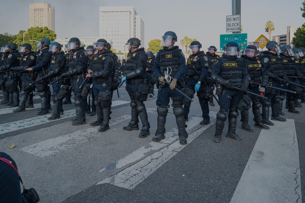 An image of riot police in formation at a recent protest