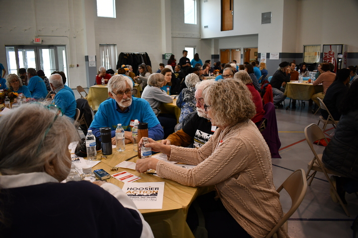 Photo of a group of adults meeting around a circular table.