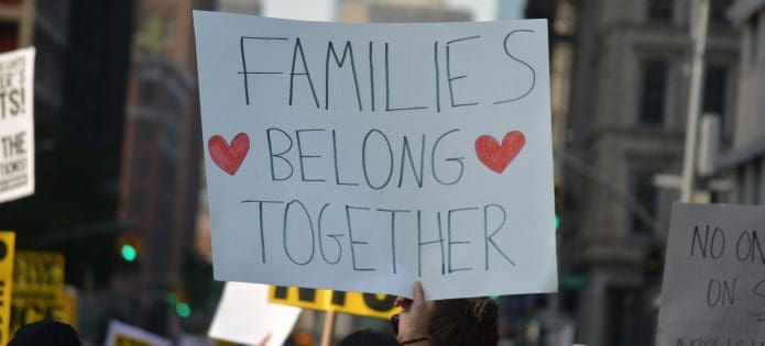 A photo of a protest sign reading, "Families belong together."