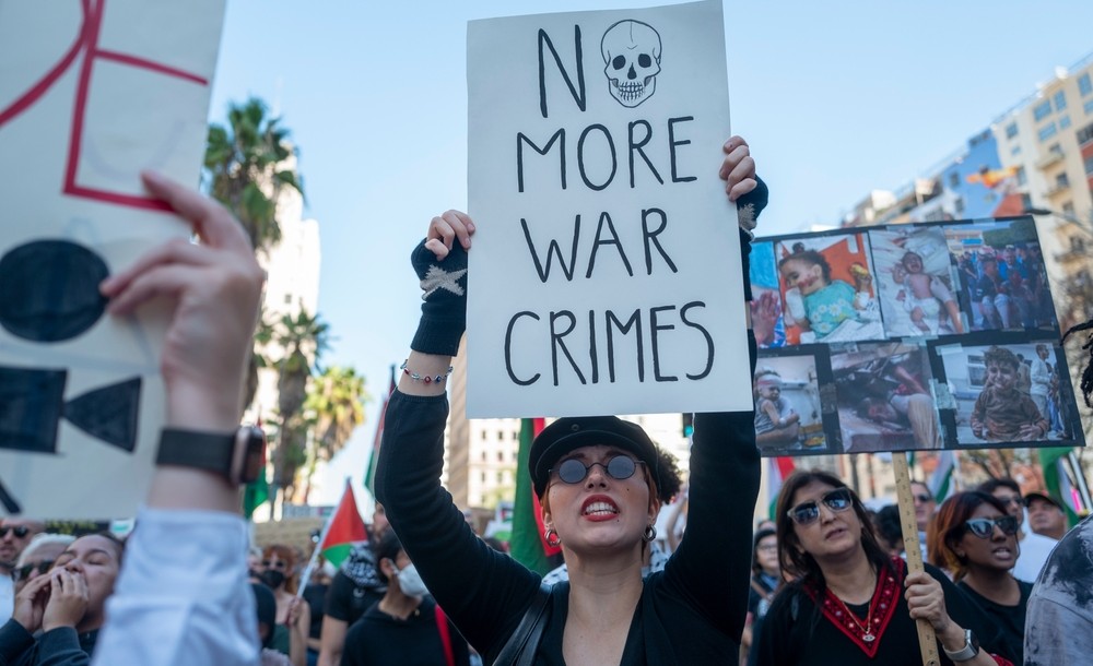 Protestors holding various anti-war signs