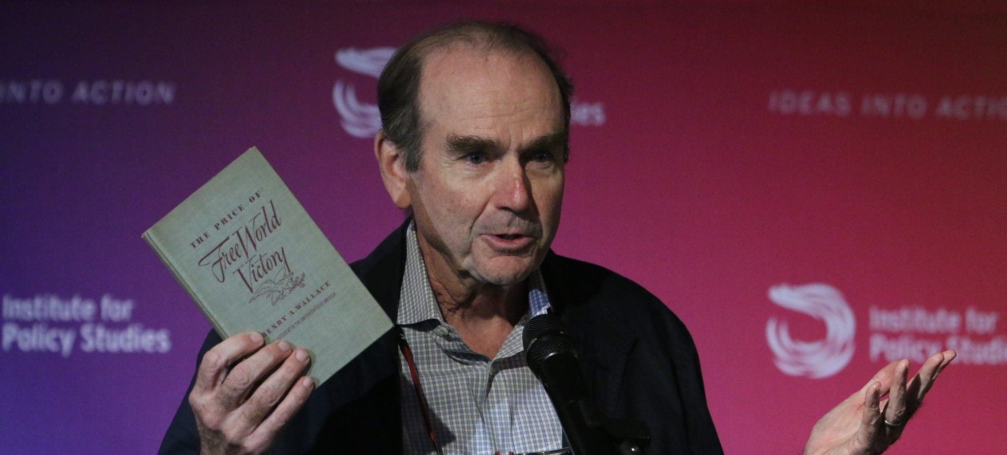 Scott Wallace holds a copy of Henry A. Wallace's "Free World Victory," which includes his "Century of the Common Man" address. (Photo by Rick Reinhard for IPS.)