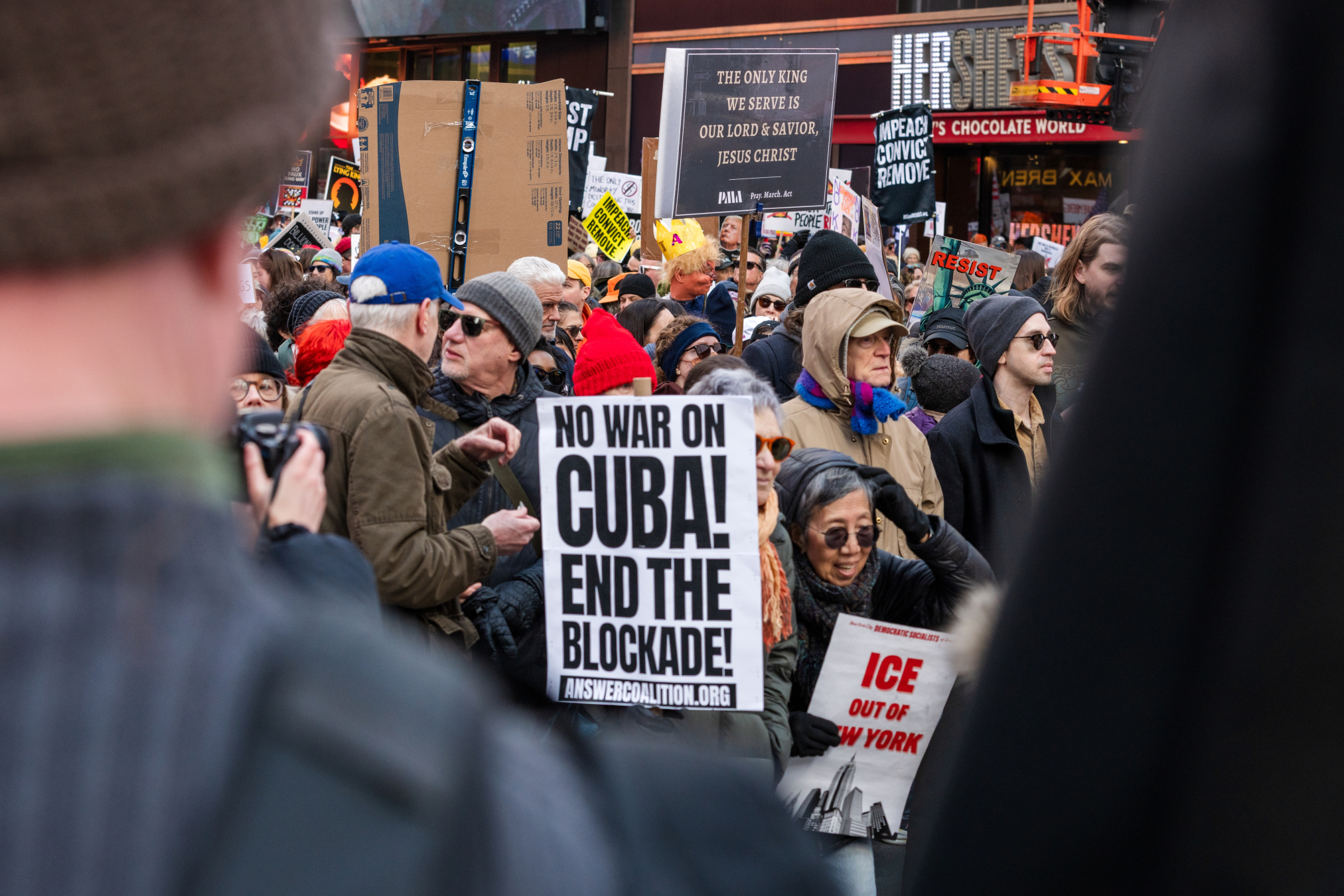 Photo of protesters and a sign reading, "No War with Cuba! End the Blockade!"